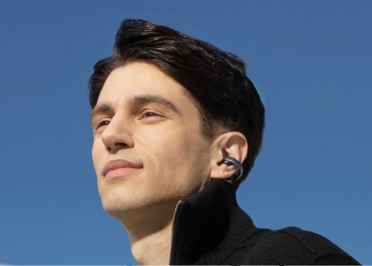 A man wearing soundcore AeroClip open-ear earbuds