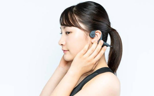 Young woman wearing a bone conduction headphones
