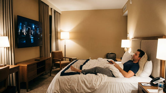 Lying on a bed in a hotel